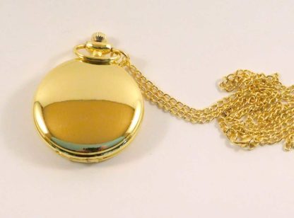 A gold fob watch with gold chain - closed