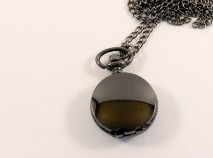 A small bloack (gun metal) fob watch - smooth, no etching on the front
