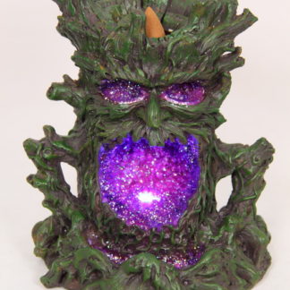 A treeman with an incense cone holder in his head - he has pink / purple glittery eyes and a big open mouth which is also pink and sparkling