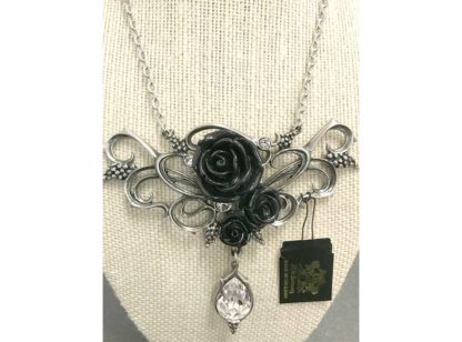 The black roses are surrounded by swirling silver and silver bunches of grapes with a clear, sparkling teardrop crystal at the bottom