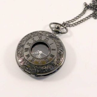 Gun metal black fob watch - closed - with neck chain. The cover is etched with a swirling pattern and it has roman numerals etched around a centre clear panel showing the watch underneath