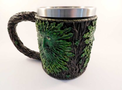 A side view of the tankard showing the multiple greenman faces around the tankard