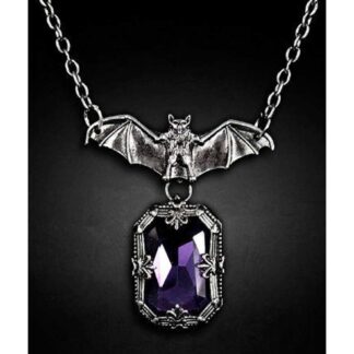 A gorgeous square faceted purple stone provides the centre piece - its surrounded by ornate metal detailing. A bat - wings outstretched sits on the gem and the chain connected to the edges of the wings