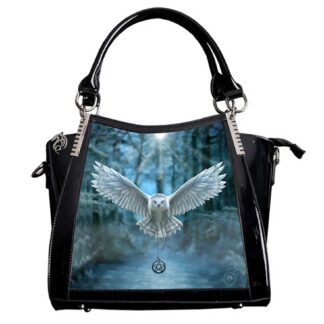 This handbag has a front panel featuring a snowy white owl flying towards you, a pentagram on a chain clasped in its claws. The owl is flying out of a blue and grey forest.