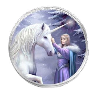 A white unicorn stands with one leg raised in front of a blond woman who is wearing a purple dress and blue fur lined cloak. She is caressing the unicorn's face. The background is a blue, purple and white winter forest scene. The round purse is silver.