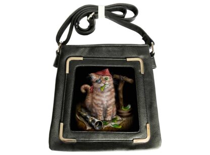 An orange tabby kitten with an eye patch and red hat perched jauntily over one ear, green feathers in its mouth is the image on the front of this black side bag.